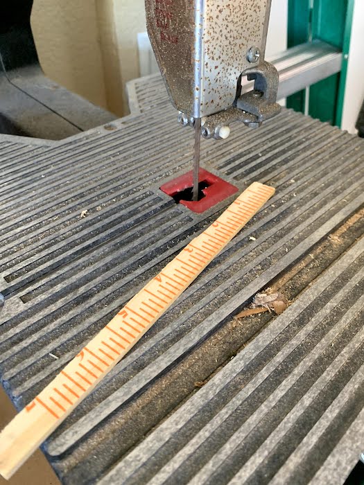 cutting the paint stick on the band saw