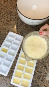 Pouring lemon juice into ice trays